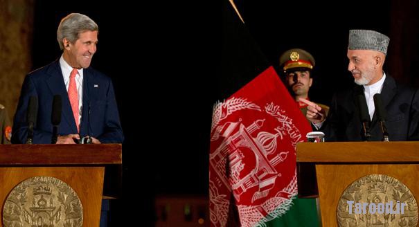 Afghanistan's President Hamid Karzai (right) points toward Kerry as he jokes with him at the start of a news conference at the Presidential Palace in Kabul on Oct. 12. | Reuters