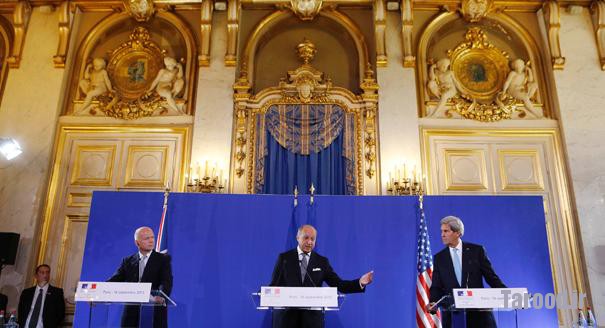 Kerry (right) and British Foreign Secretary William Hague (left) listen to French Foreign Minister Laurent Fabius speak at a news conference after a meeting regarding Syria, at the Quai d'Orsay in Paris on Sept. 16. | Reuters
