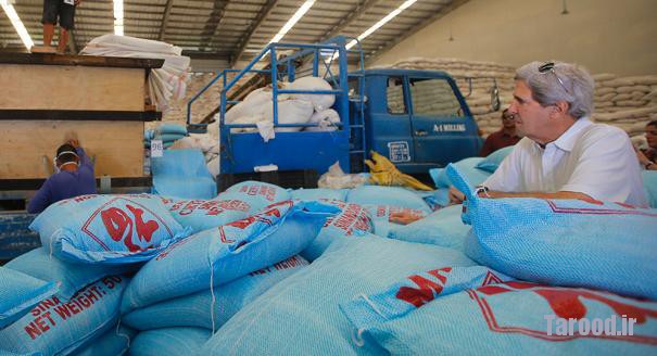 Kerry looks at bags of rice in a relief distribution center during a tour of the damage from Typhoon Haiyan in Tacloban, Philippines, on Dec. 18. Kerry announced that the U.S. government, through USAID, will provide an additional nearly $25 million in humanitarian aid for the survivors of Typhoon Haiyan, which decimated towns and villages around Tacloban on Nov. 8, killing more than 6,000 people and displacing 4 million. | Reuters