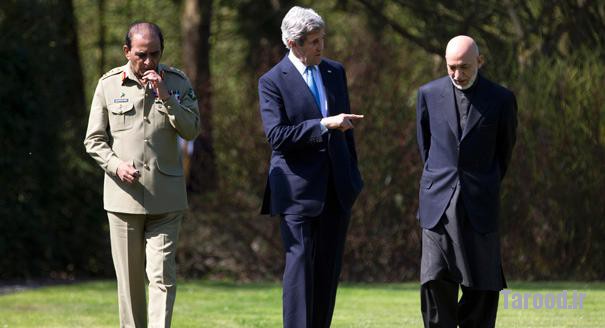 Kerry (center) talks with Afghan President Hamid Karzai (right) and Pakistani Army Chief General Ashfaq Parvez Kayani as they take a walk during a break in a meeting in Brussels on April 24. | Reuters